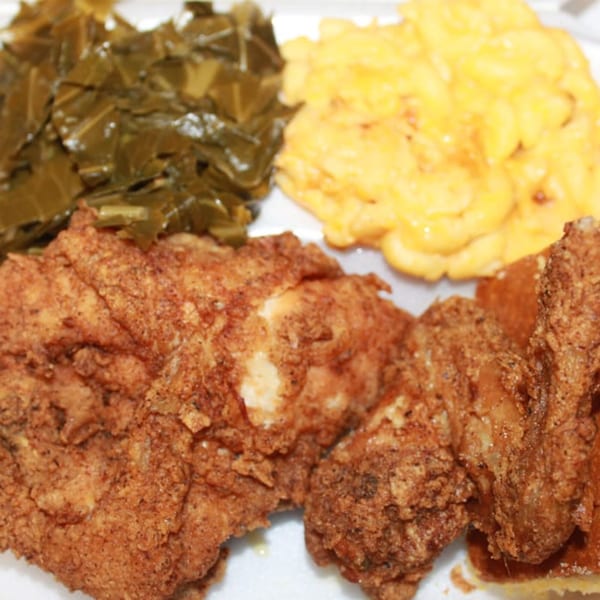 Aunt Berta's Kitchen soul food plate with fried chicken, collard greens, and macaroni and cheese.
