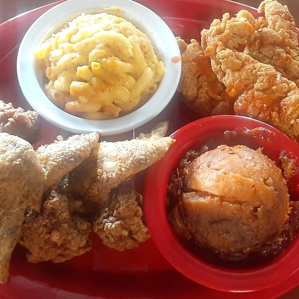 Aunt Berta's Kitchen soul food plate with fried chicken, mac and cheese, and candied yams.