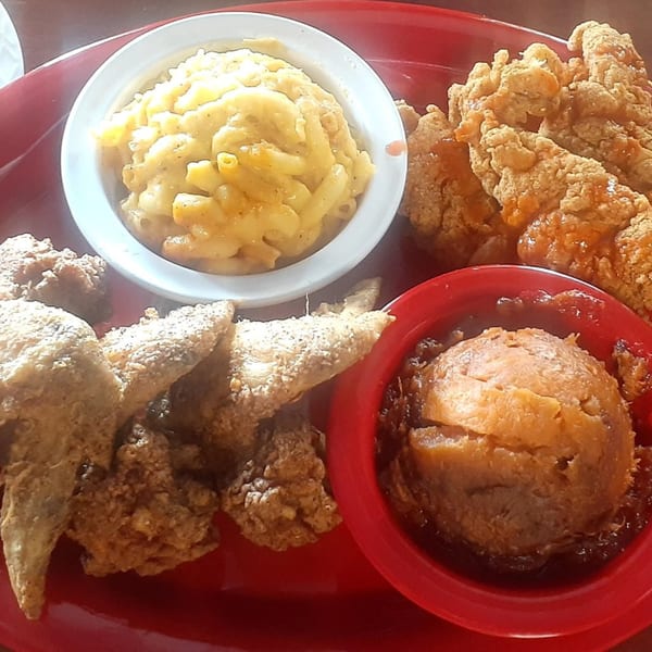 Aunt Berta's Kitchen soul food platter with fried chicken, macaroni and cheese, and candied yams.
