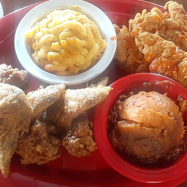 Aunt Berta's Kitchen soul food platter with fried chicken, macaroni and cheese, and candied yams.