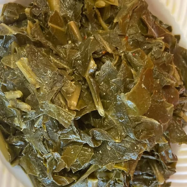 Close-up of a serving of Aunt Berta's Kitchen's soul food collard greens.